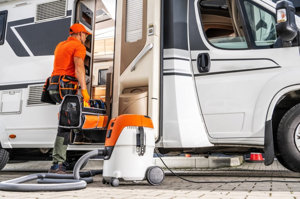 Cleaning Camper Van With Professional Equipment in Outdoor Area