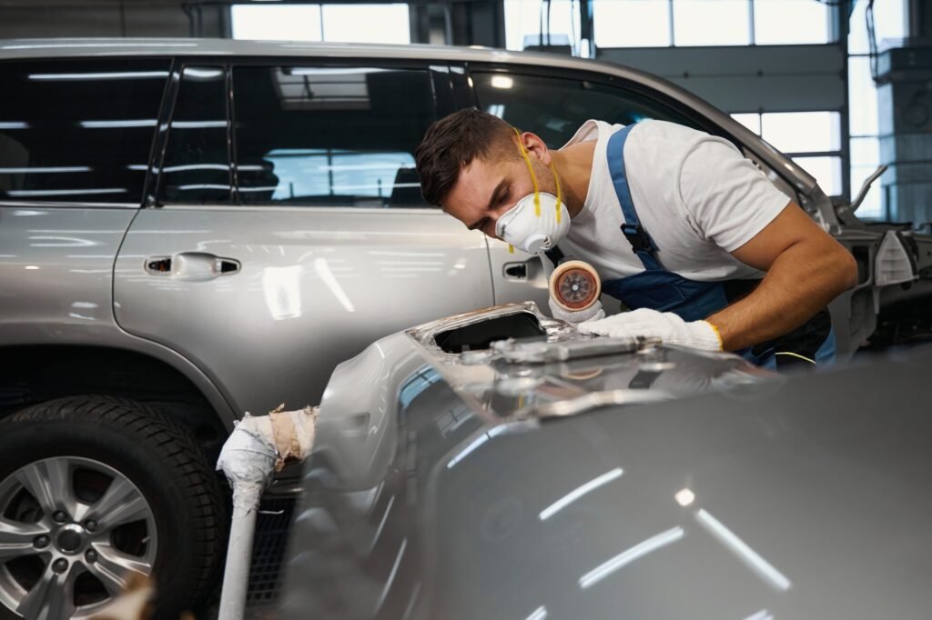 Mechanic polish surface of auto, prepare for repair